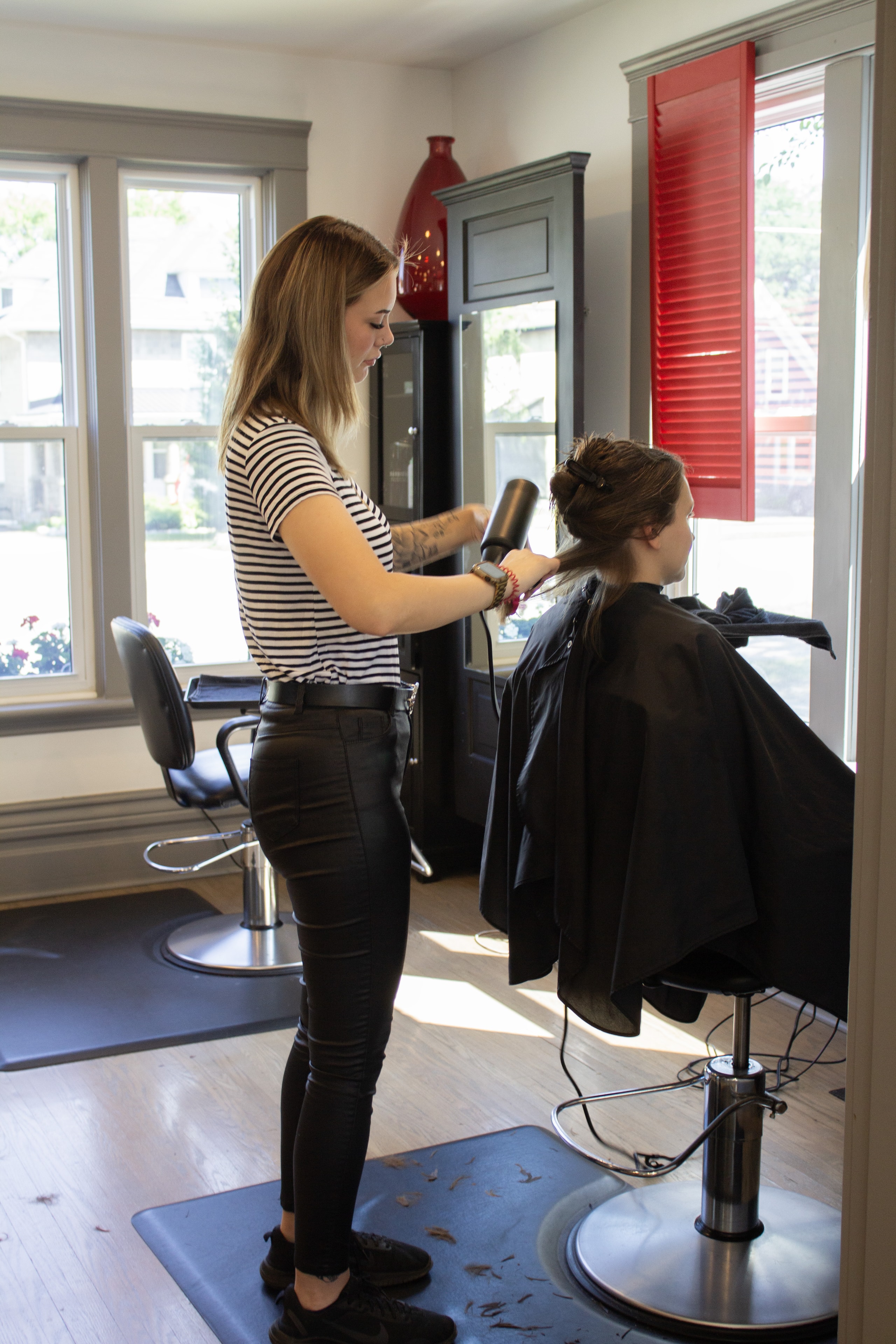 Jaime styling a client's hair at Village Hair Co.