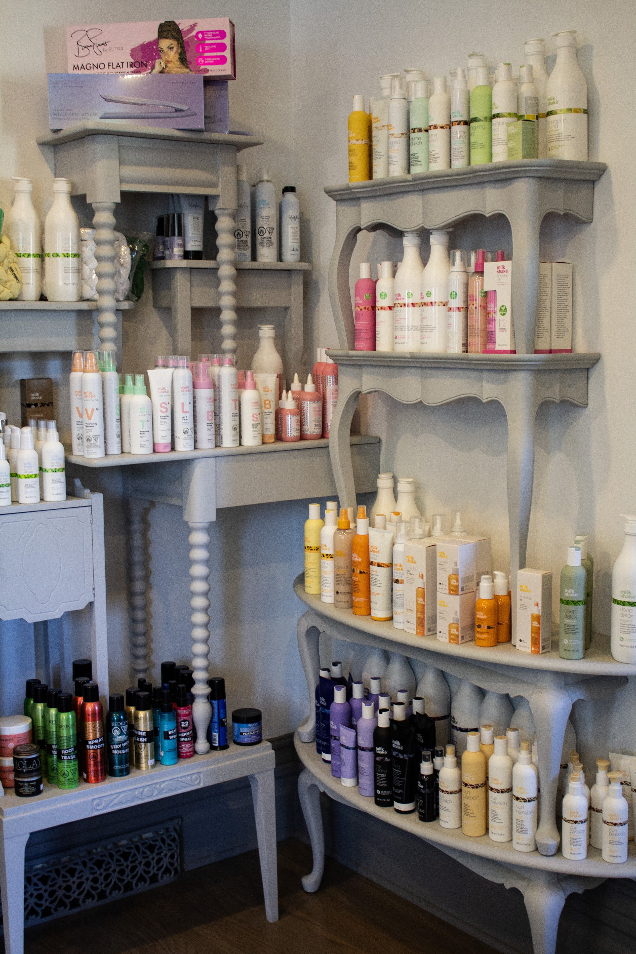 Beauty products organized on shelves at Village Hair Co.