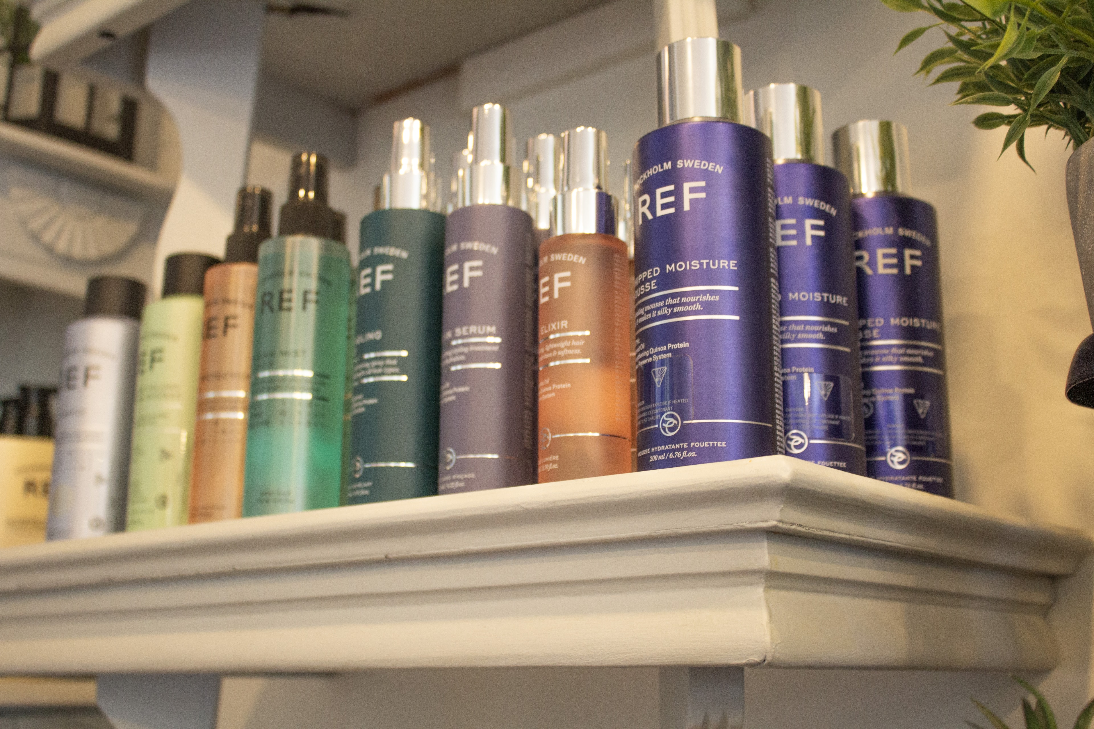 REF hair and skincare products on display at Village Hair Co.
