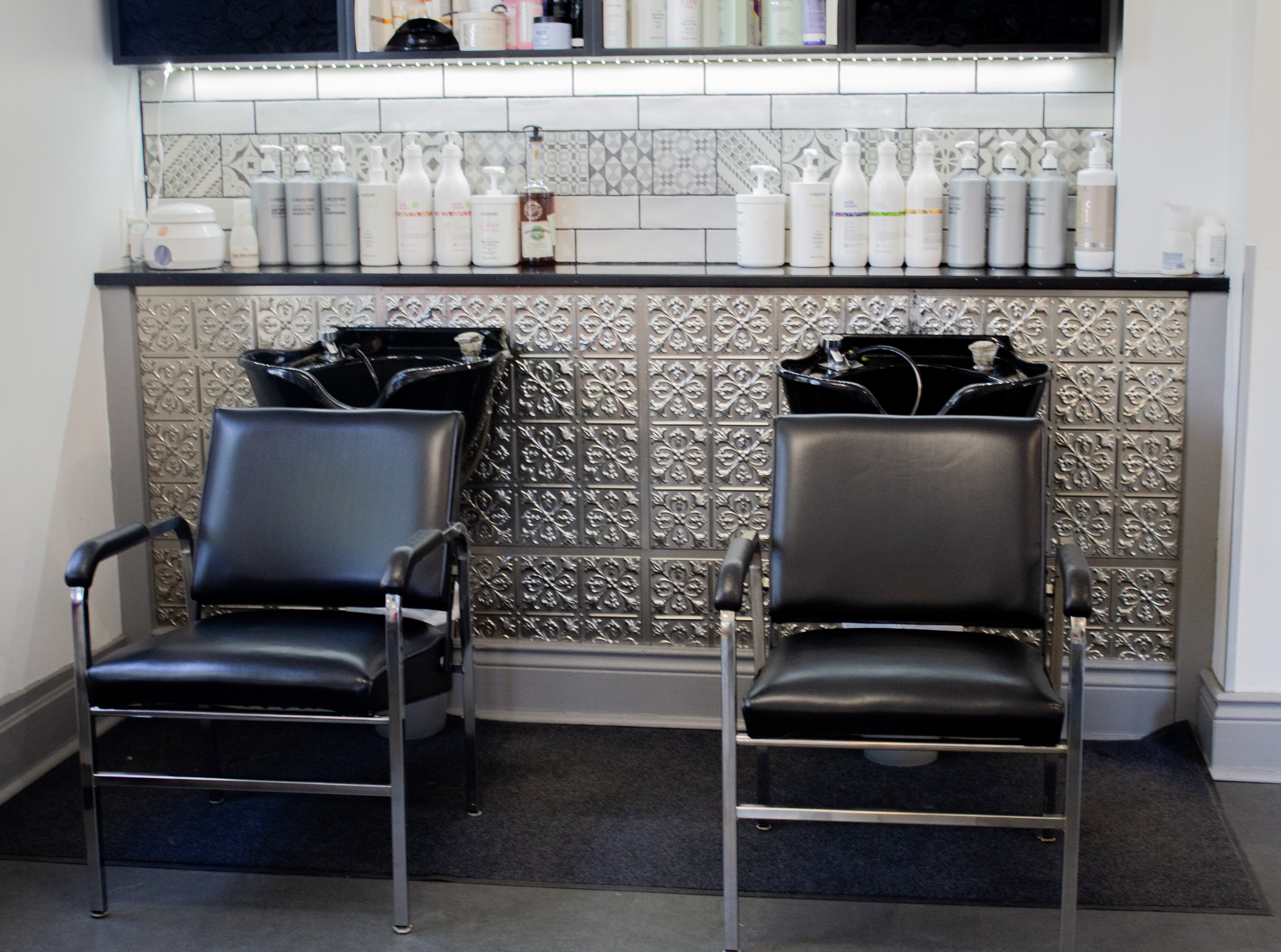 Village Hair Co. wash station with black chairs